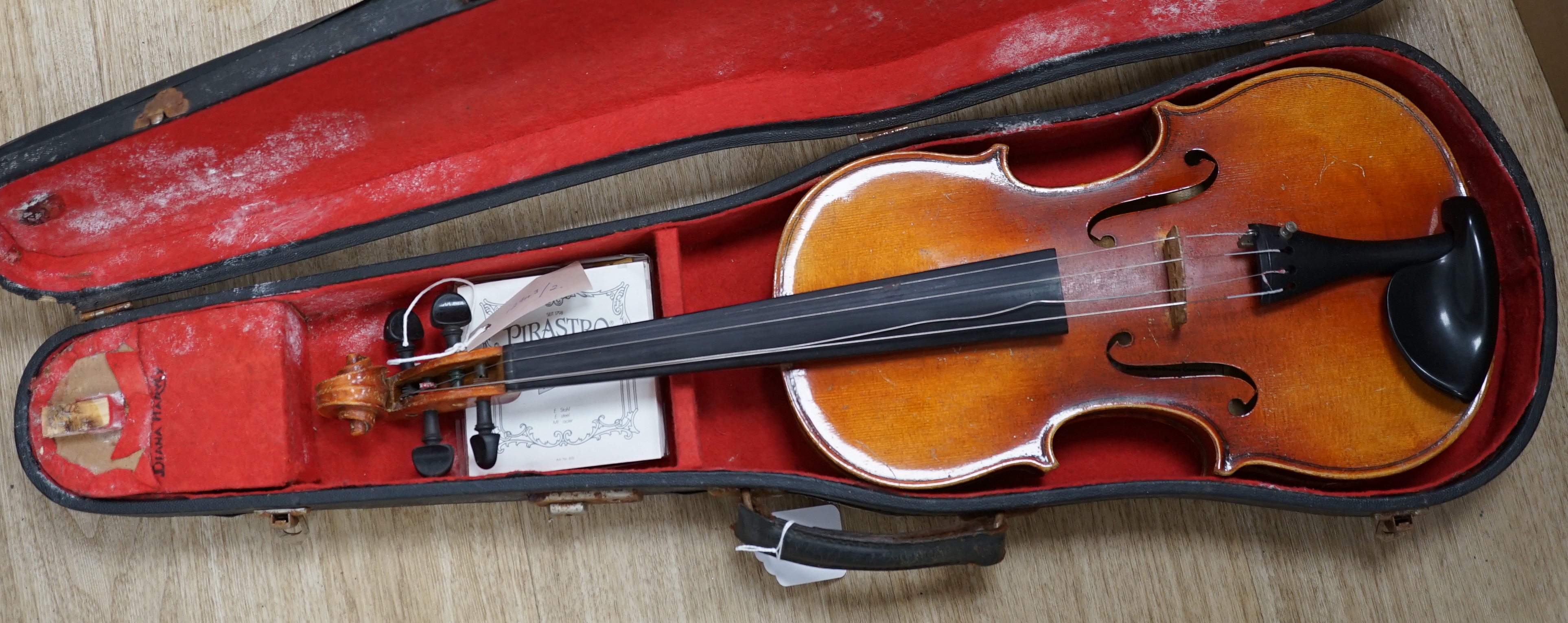 A cased Czechoslovakian student’s violin with Stradivarius label, length of body, 35.5cm, with spare strings